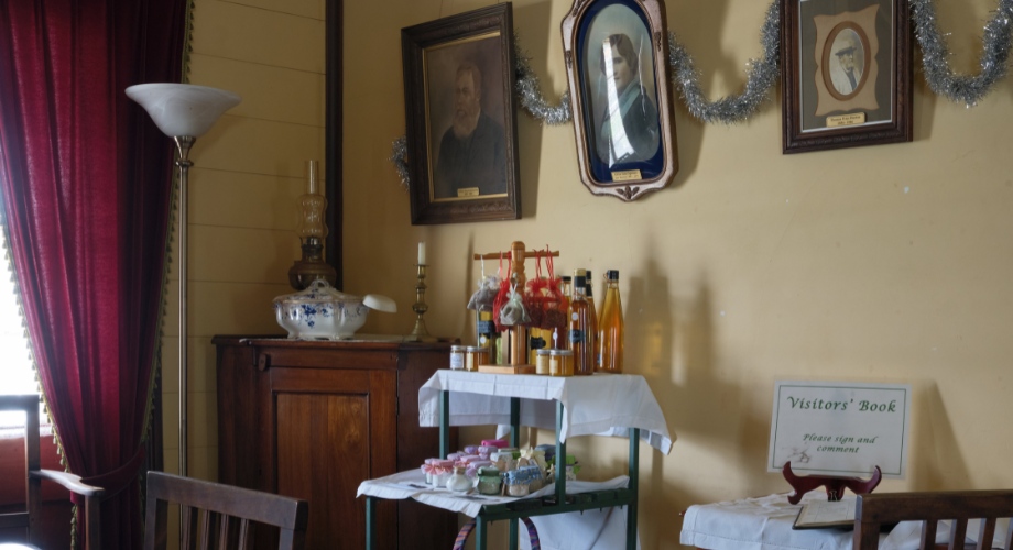 Room with vintage decor and a table displaying small bottles and souvenirs.