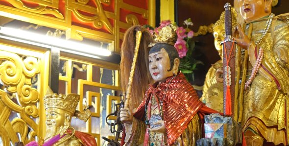 Ornate religious statues with gold and red decorations.